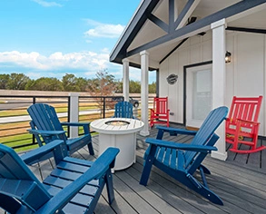 chairs and swimming pool at Firefly Resorts with Hill Country views